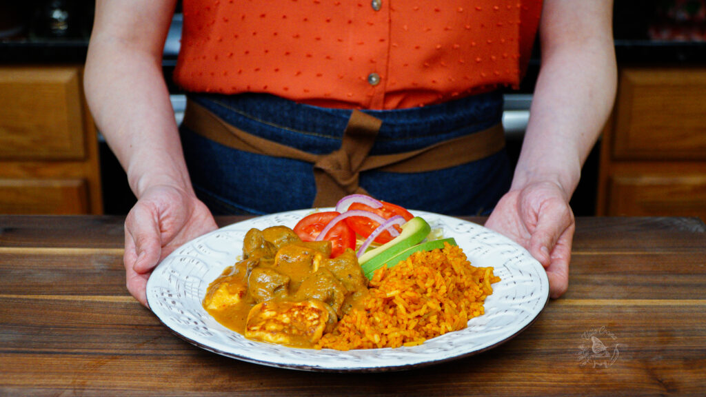 a person holding a plate with a Mexican beef stew recipe in it