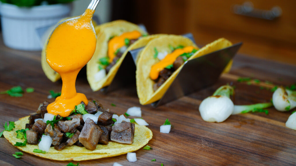 beef tongue tacos topped with Chile de arbol salsa