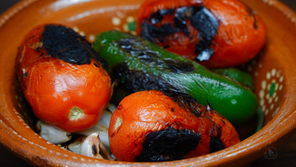 roasted tomatoes and peppers in a bowl for an Authentic Red Salsa recipe