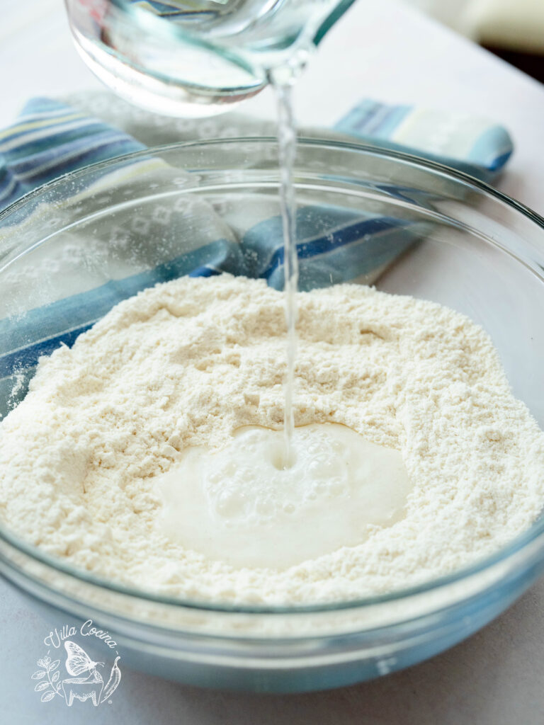 Water being applied to corn masa