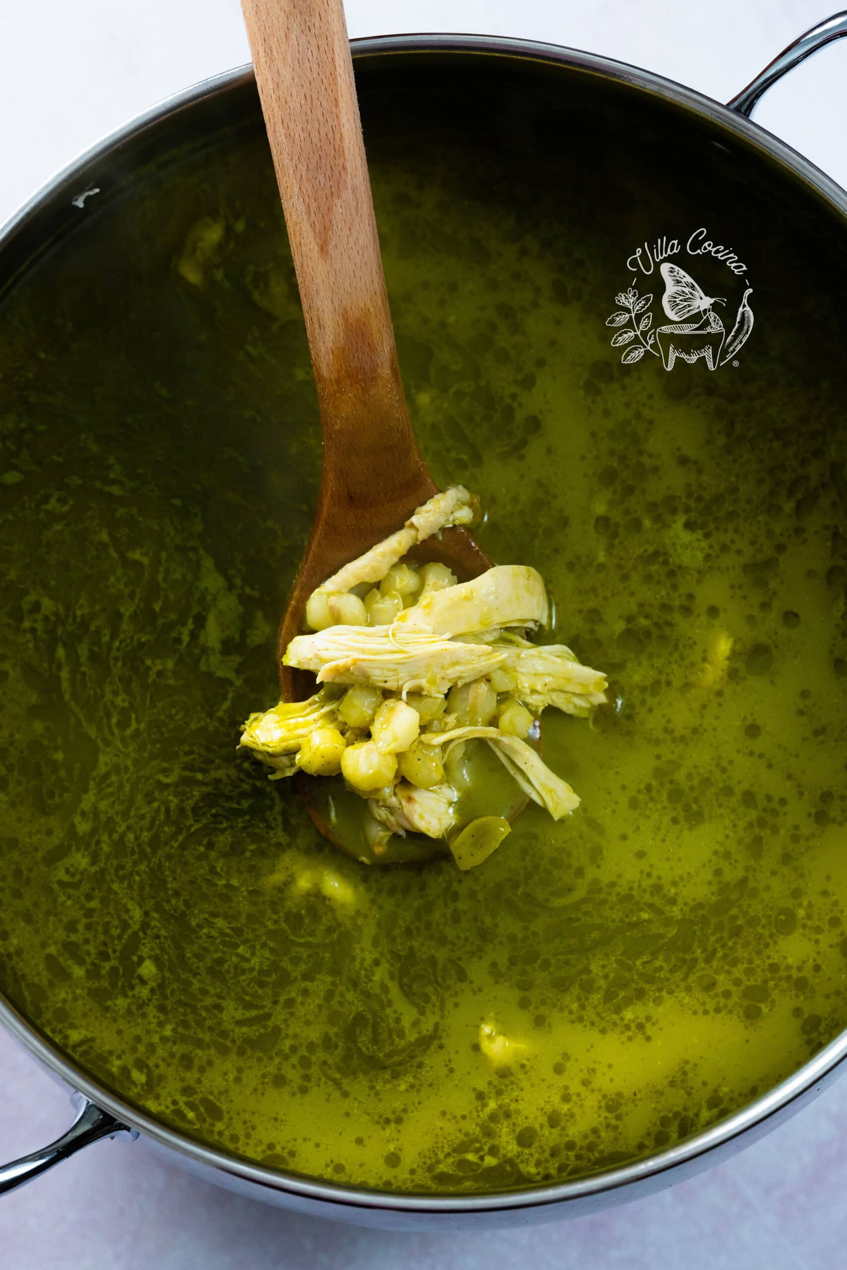 Stir in the chicken to the pozole and season with salt. 