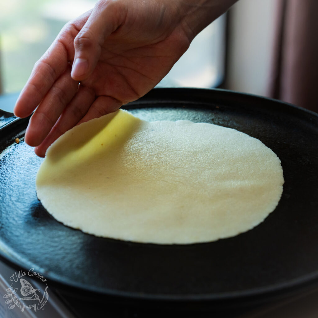 Round tortilla starting its cooking process.