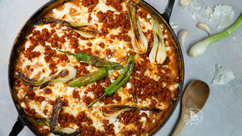 Refried beans with chorizo in safe oven pan