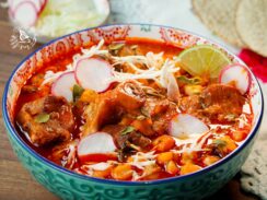 This is an Authentic Pozole Rojo. It is made with pork, Hominy, dried peppers for the sauce, spices, and your choice of toppings.