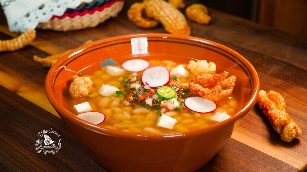 Frijoles de la Olla (Mexican beans) topped with pico de Gallo, chicharrones, and serrano pepper.