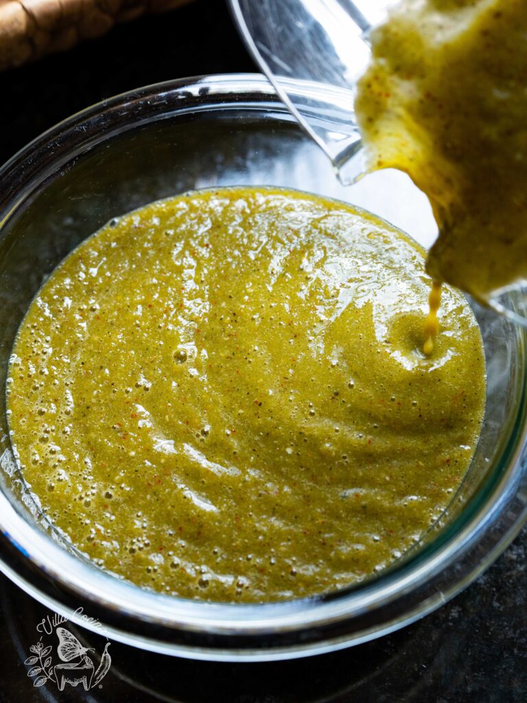 Pouring a salsa verde taquera