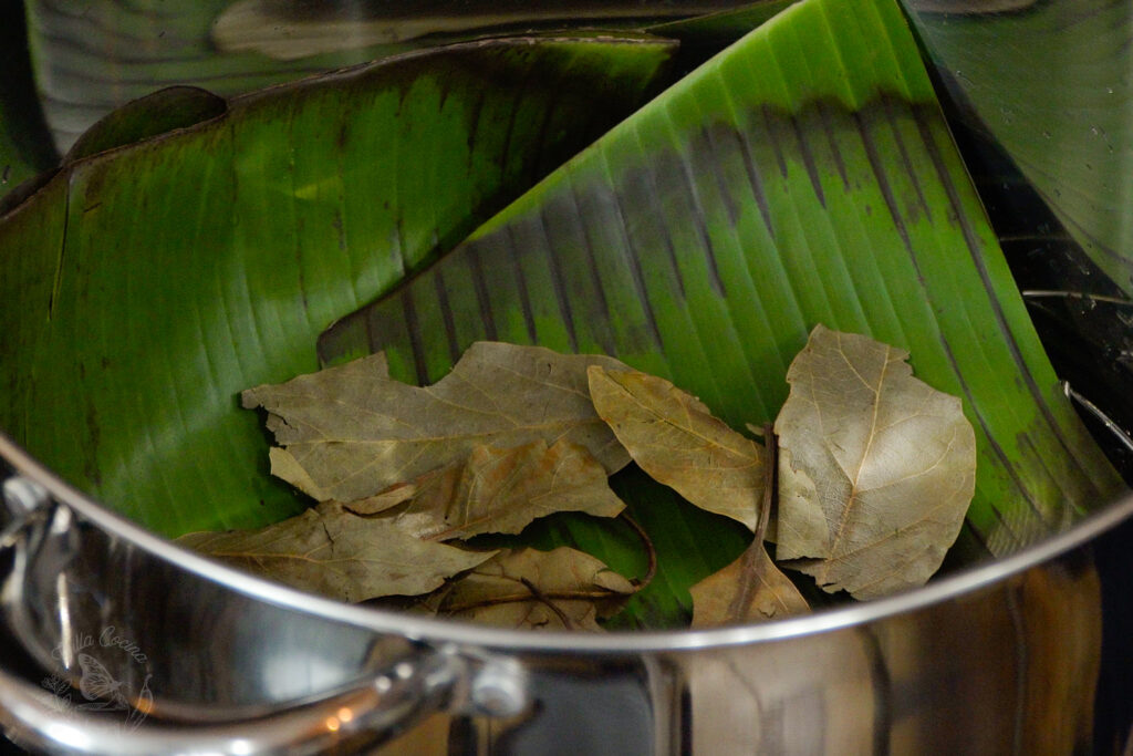 Avocado and banana leaves in a pot, ready for a beef barbacoa.