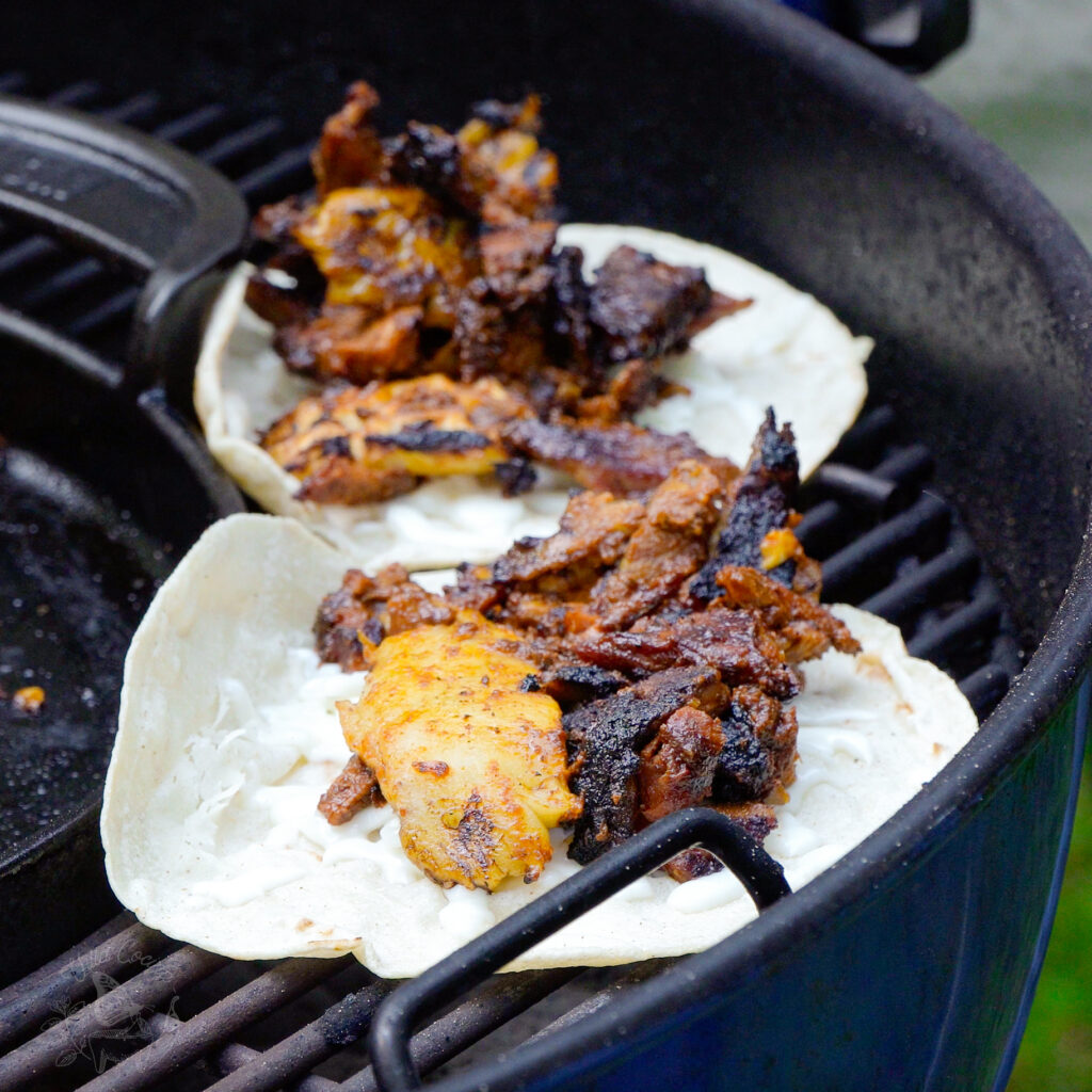 Tacos al Pastor on the grill and ready to serve.