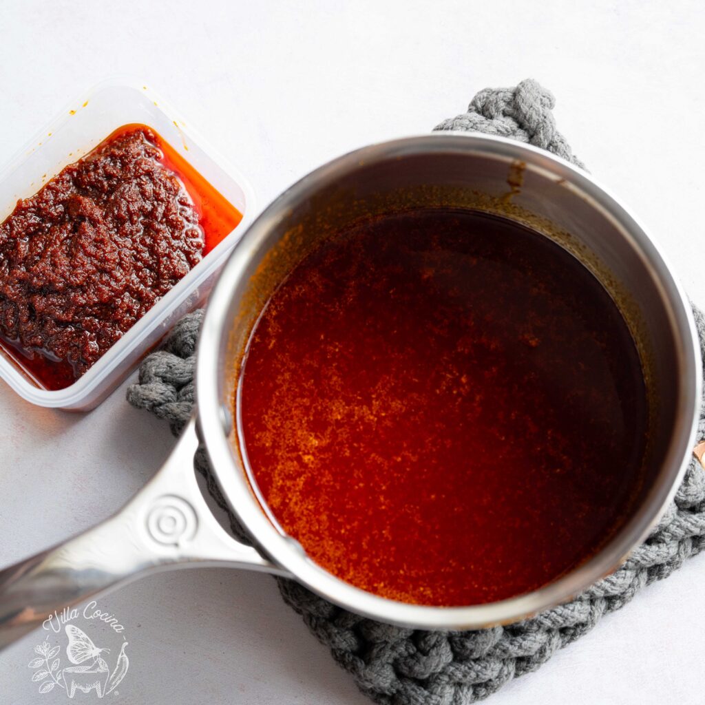 Chilli oil in a pot, next to the chili leftovers.