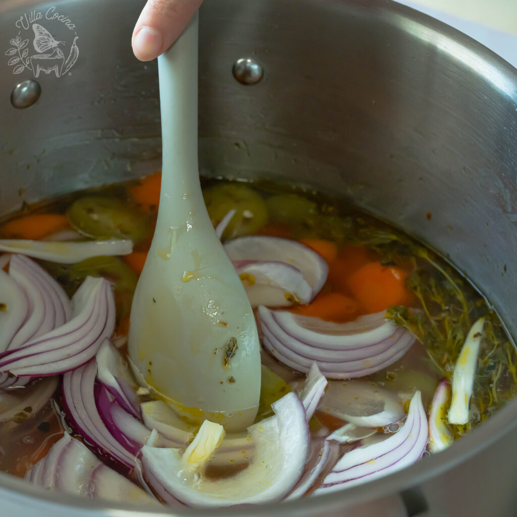 Stirring all the ingredients on an quick pickled carrots recipe.