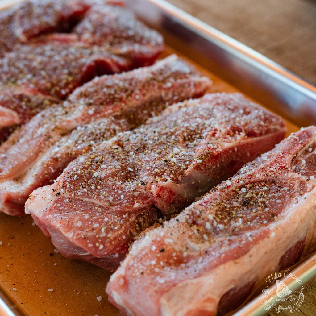 Pork ribs sprinkled with salt and pepper.