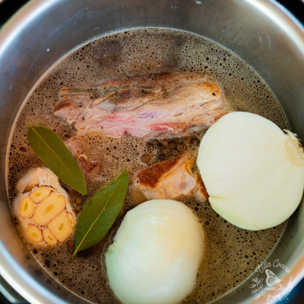 Pork ribs ready to be cooked along with aromatics.