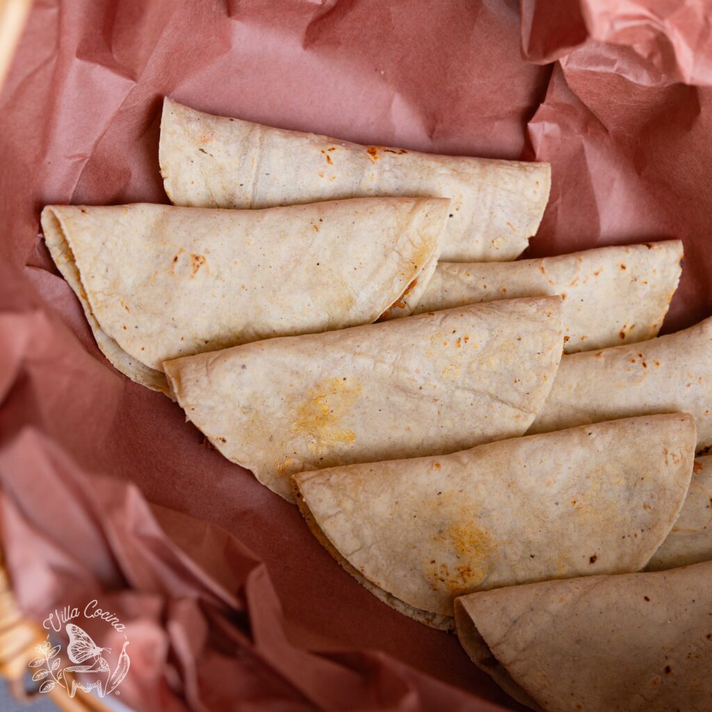 A layer of tacos de canasta