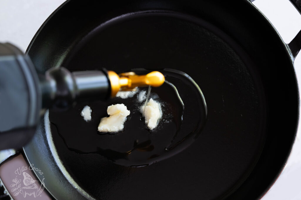 overhead photo of oil being added to a pan