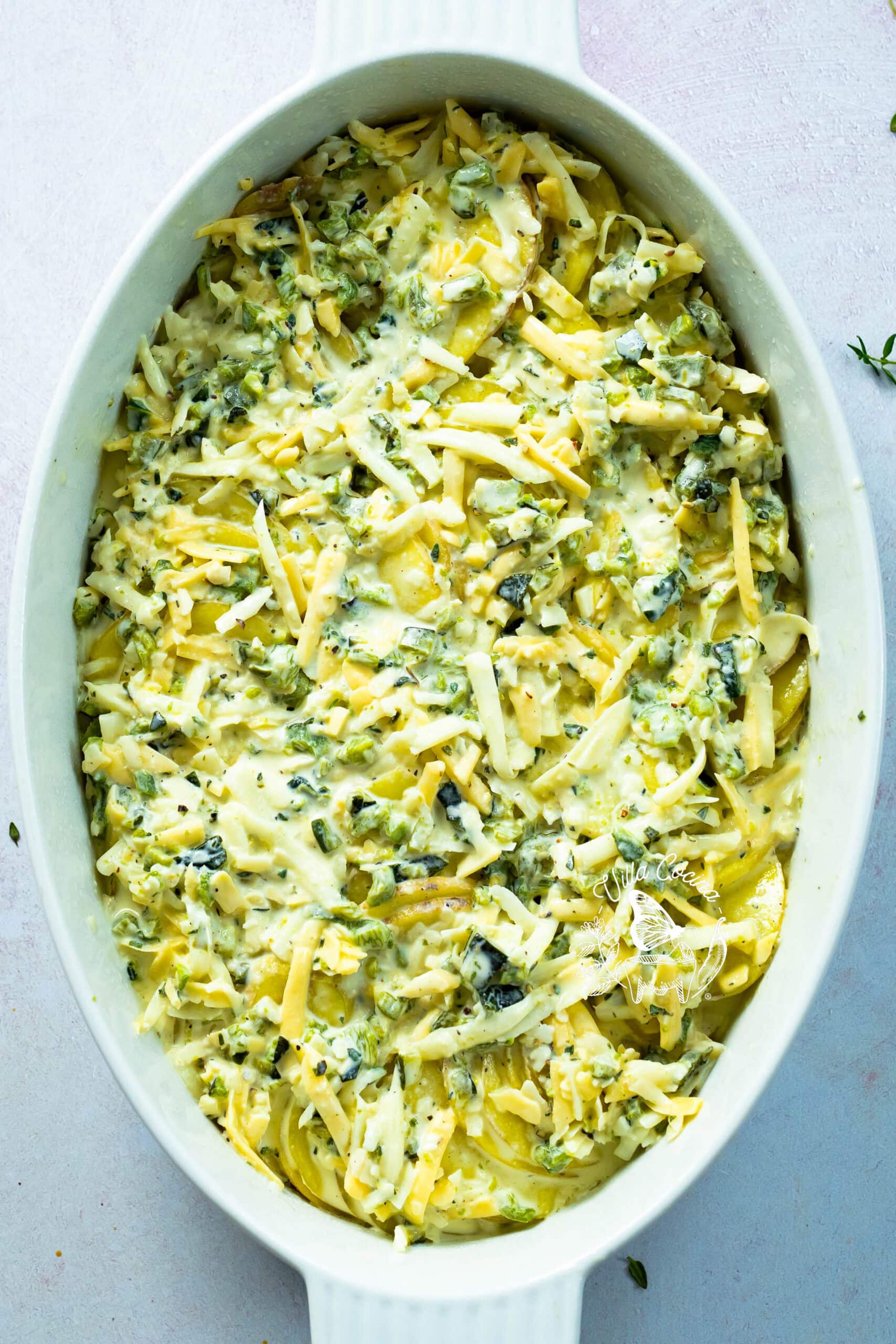 Layered potato casserole before adding the remaining cream mixture.