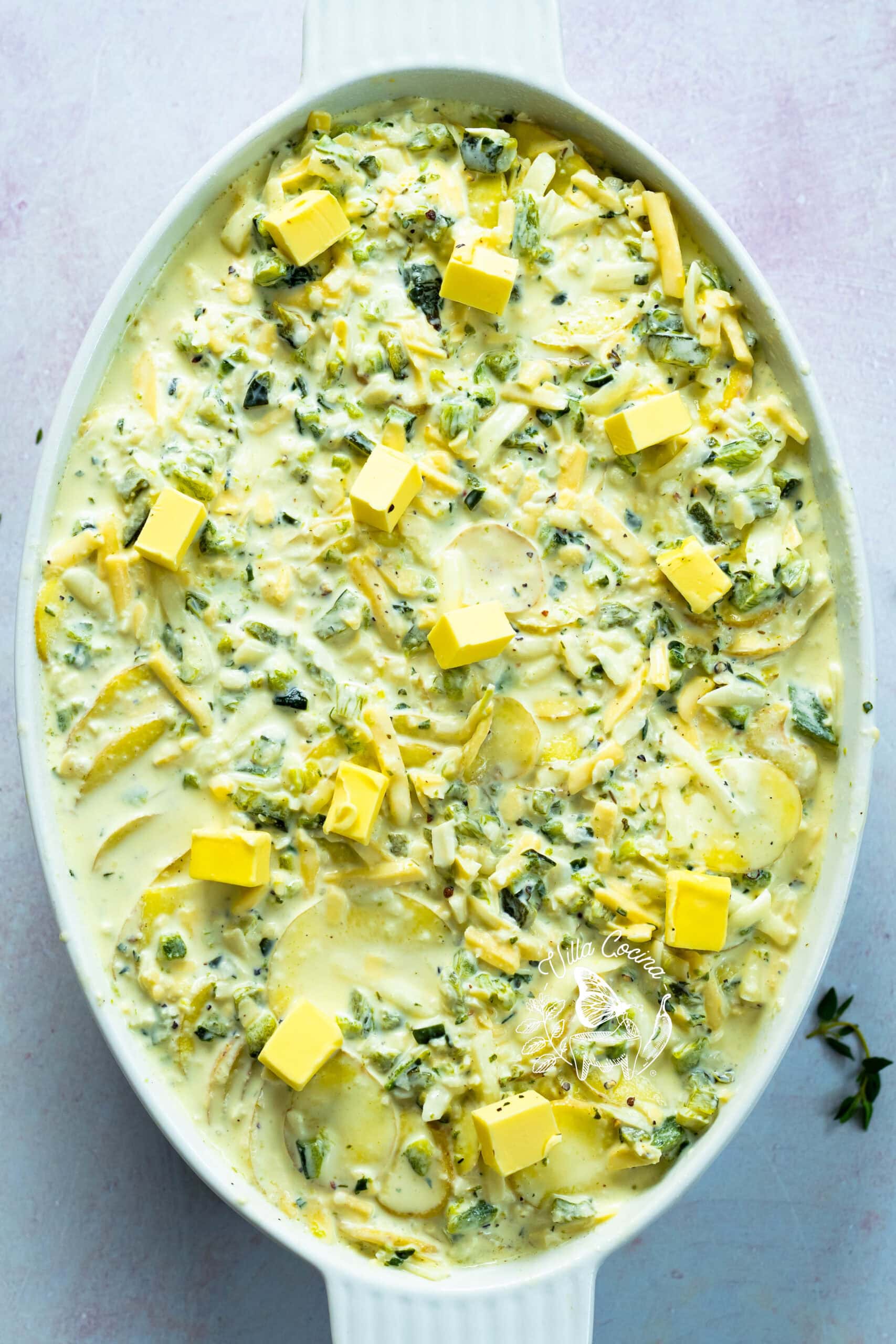 All cream added to the layered potatoes and dotted with butter before baking.