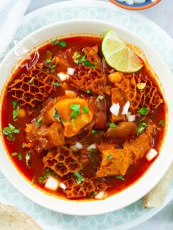 Instant Pot menudo, tender and hot, topped with classic Mexican garnishes.