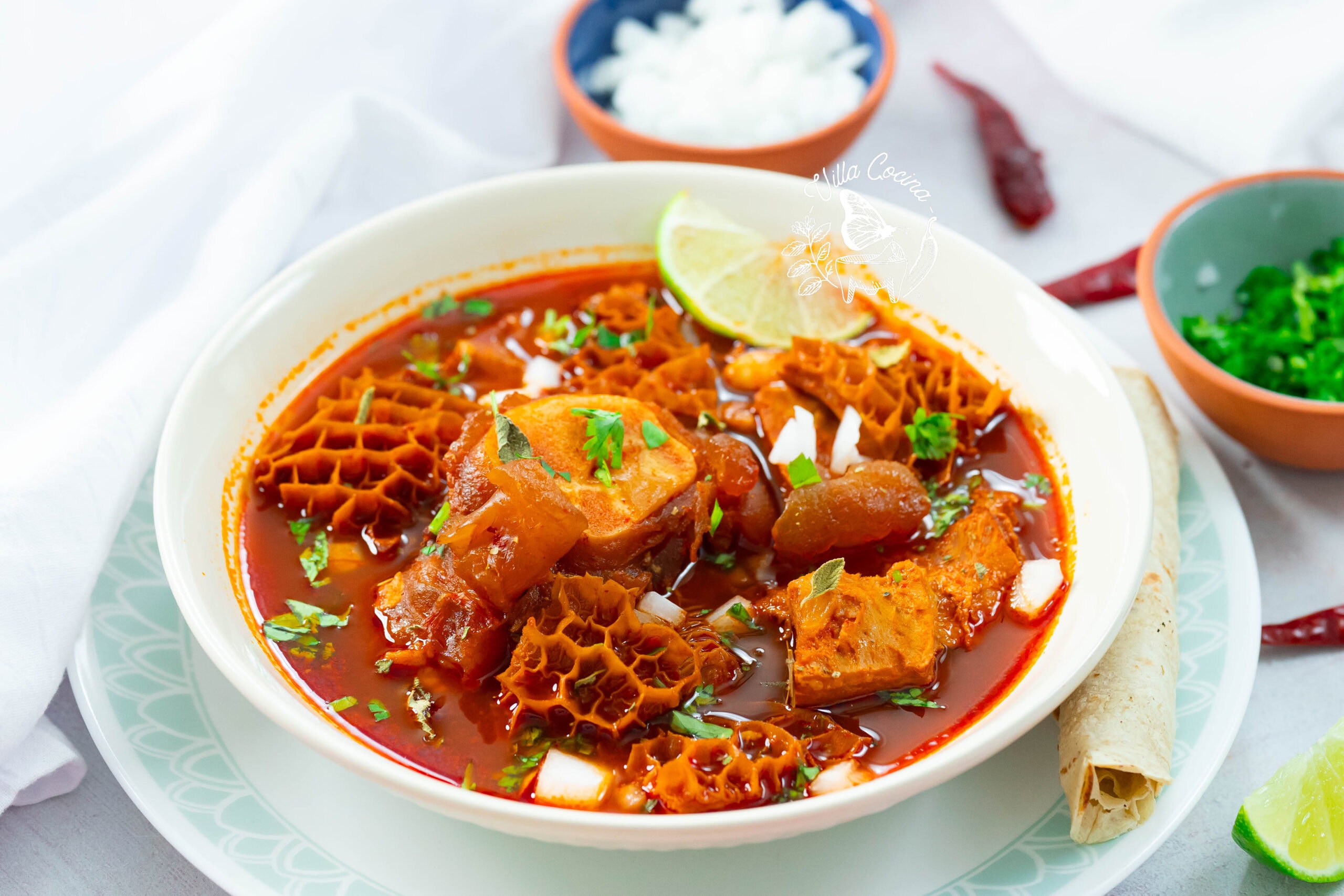 Instant Pot menudo, tender and hot, topped with classic Mexican garnishes.