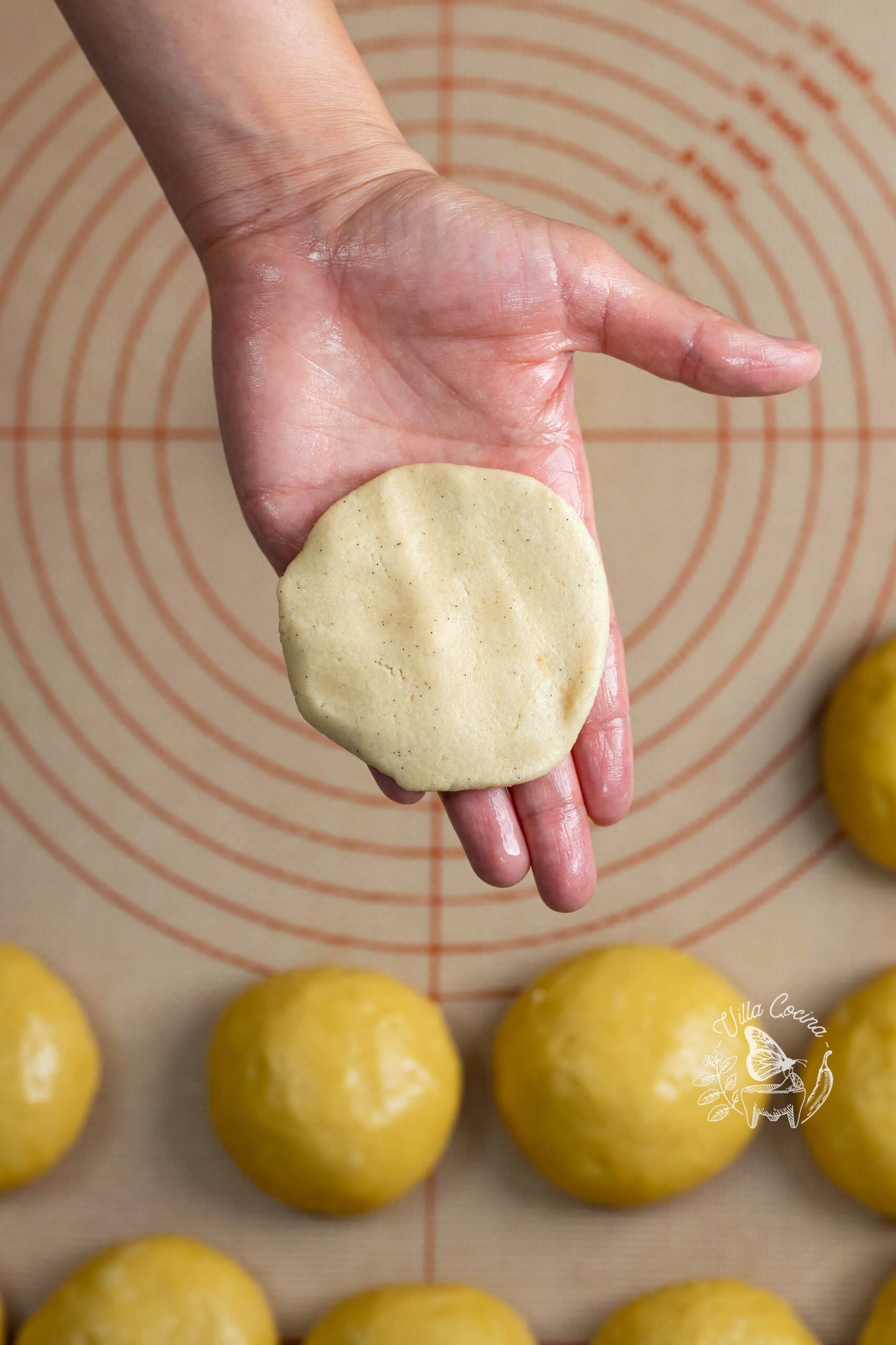 Flattened vanilla sugar topping held in a buttered hand.